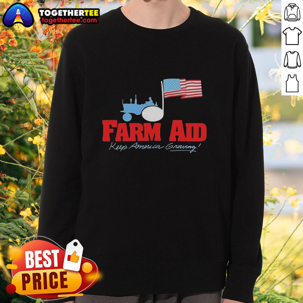 Premium Farm Aid Keep America Growing The Logo Of A Tractor And The American Flag Sweatshirt Premium Farm Aid sweatshirt featuring a tractor logo and American flag design, supporting farmers and agriculture.