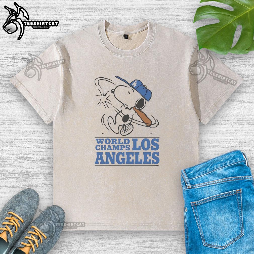 premium-snoopy-x-los-angeles-dodgers-world-champs-cartoon-washed-t-shirt Alt Text: Premium Snoopy X Los Angeles Dodgers World Champs cartoon washed t-shirt featuring Snoopy celebrating baseball victory.