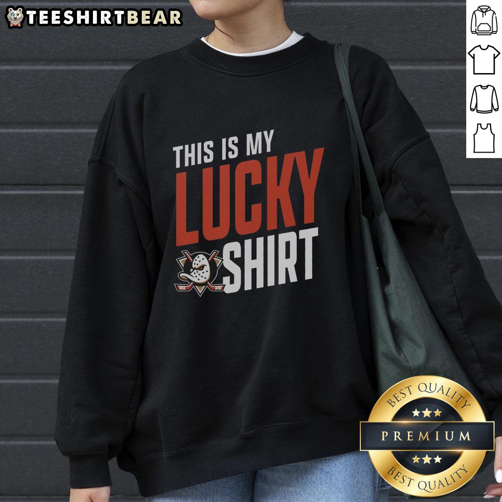 pretty-anaheim-ducks-this-is-my-lucky-sweatshirt Young fan wearing a lucky Anaheim Ducks sweatshirt, showing team spirit at a hockey game, smiling with excitement.