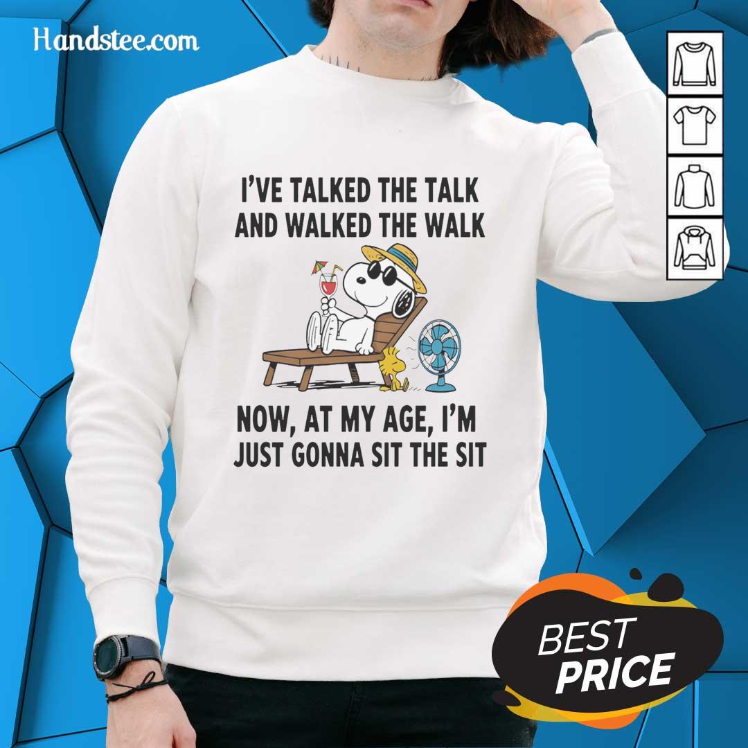 pretty-snoopy-ive-talked-the-talk-and-walked-the-walk-now-at-my-age-im-just-gonna-sit-the-sit-sweatshirt Cozy Pretty Snoopy sweatshirt featuring a playful quote about aging and relaxation, perfect for casual wear.