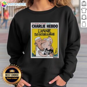 Two men kissing in 'L'Amour Plus Fort Que La Haine' sweatshirt, symbolizing love and unity after Charlie Hebdo.