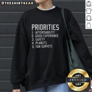 Original Priorities sweatshirt featuring affordability, good experience, safety, and peanuts fan surveys design.