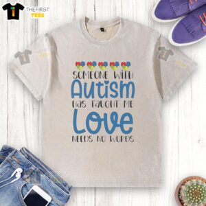 Person wearing a washed t-shirt with 'Love Needs No Words' print, highlighting autism awareness and acceptance.