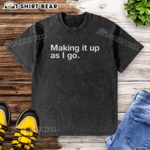 Alt Text: Woman wearing a Pretty Making It Up As I Go washed t-shirt, showcasing casual style and comfort in a vibrant outdoor setting.