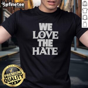 Alt Text: Official We Love The Hate T-Shirt featuring bold graphic design and vibrant colors, perfect for fans of edgy fashion.