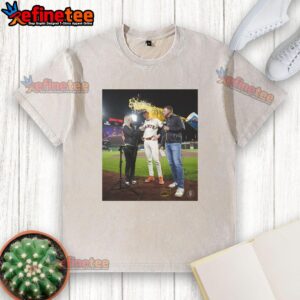 Top Daniel Susac of the San Francisco Giants gets water thrown on him while wearing a washed T-shirt during a game.