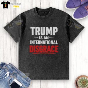 Alt Text: Pretty Trump is an International Disgrace washed t-shirt featuring bold graphic design and vibrant colors.
