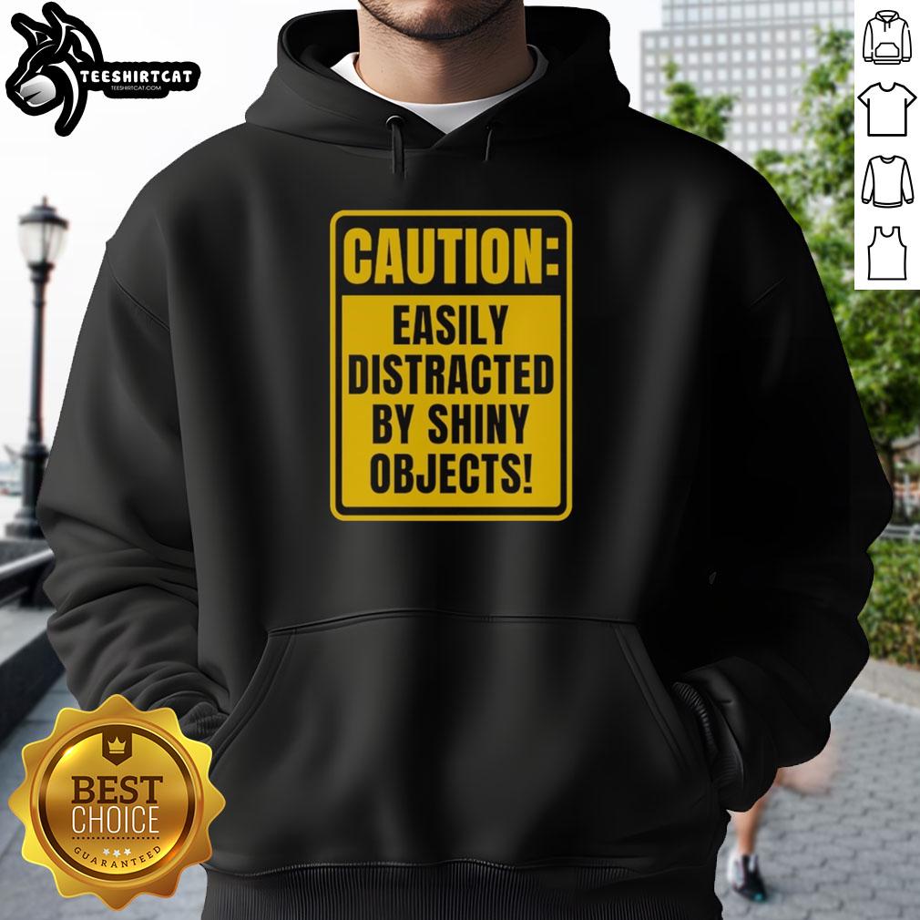 top-caution-easily-distracted-by-shiny-objects-hoodie Alt Text: Top Caution Easily Distracted By Shiny Objects Hoodie in vibrant colors, perfect for casual wear and quirky style.