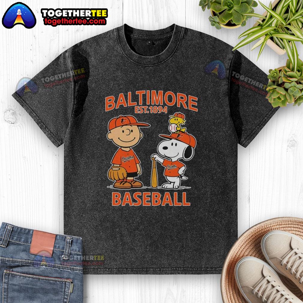 Top Charlie Brown Snoopy And Woodstock With Baltimore Orioles Baseball Jersey Est 1894 Washed T-Shirt Alt Text: Charlie Brown, Snoopy, and Woodstock in a Baltimore Orioles baseball jersey, vintage washed t-shirt design.