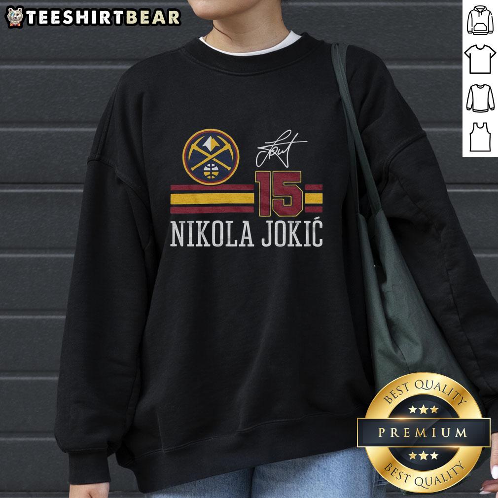 top-nuggets-nikola-jokic-signature-jersey-sweatshirt Alt Text: Nikola Jokic signature jersey sweatshirt featuring the Denver Nuggets logo, perfect for fans of the NBA star.