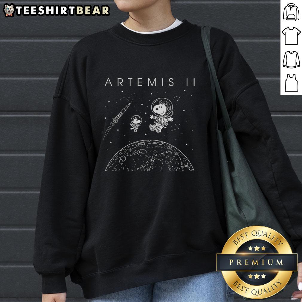 top-snoopy-and-woodstock-flying-in-outer-space-artemis-ii-of-nasa-sweatshirt Alt Text: Snoopy and Woodstock flying in outer space on a NASA Artemis II sweatshirt design.