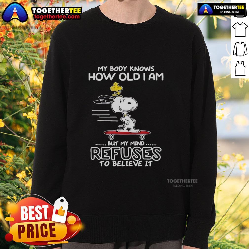 Top Snoopy Woodstock My Body Knows How Old I Am But My Mind Refuses To Believe It Sweatshirt Cozy sweatshirt featuring Snoopy and Woodstock with the phrase My Body Knows How Old I Am for fun, nostalgic fashion.
