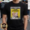 Alt Text: Two men kissing on a 'Charlie Hebdo LAmour Plus Fort Que La Haine' T-shirt, showcasing love over hate.