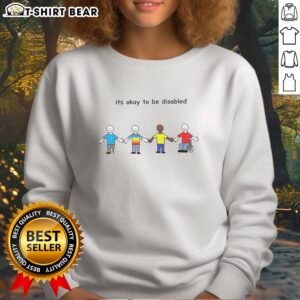 Cartoon sweatshirt featuring the phrase 'Good, It's Okay To Be Disabled' promoting disability pride and positivity.