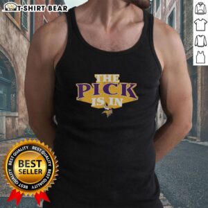 Fan wearing a Minnesota Vikings tank top celebrates top draft pick at a game, showcasing team spirit and excitement.