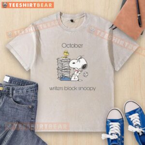 Alt Text: Cute October Writers Block Snoopy and Woodstock graphic on a washed t-shirt, perfect for fall writing vibes.