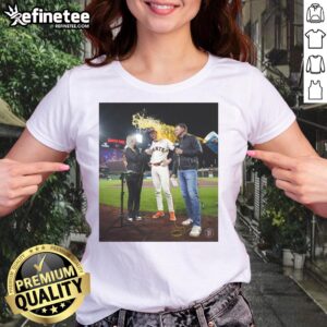 Daniel Susac of the San Francisco Giants celebrates with water thrown on him, wearing a ladies tee, capturing a joyful moment.