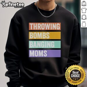 Pretty Throwing Bombs Banging Moms retro sweatshirt displayed on a wooden background, showcasing its vibrant design.