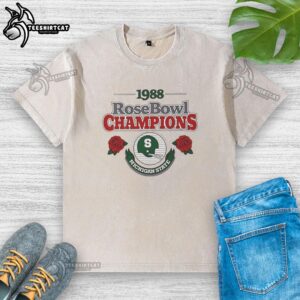 Alt Text: Official Michigan State Spartans NCAA Football 1998 Rose Bowl helmet design on a washed t-shirt, showcasing team pride.