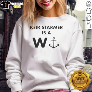 Keir Starmer wearing a stylish 'W.S.' sweatshirt, showcasing his casual fashion choice in a vibrant outdoor setting.