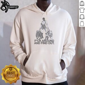 Girl in a balaclava mask walking two dogs, wearing a 'Fuck Around and Find Out' hoodie, showcasing street style.