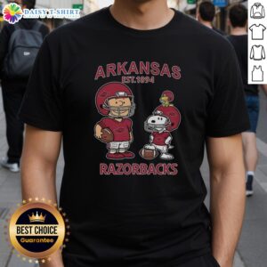 Official Charlie Brown and Snoopy Arkansas Razorbacks NCAA Football T-Shirt, Est 1894, featuring playful graphics.