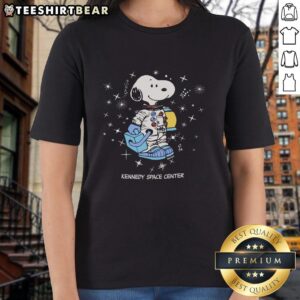 Nice Peanuts Snoopy Galaxy graphic on a Kennedy Space Center ladies tee, perfect for fans of space and classic cartoons.