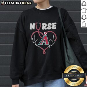 Alt Text: Official Arizona Diamondbacks Nurse It's A Work Of Heart sweatshirt with team logo and stylish design.