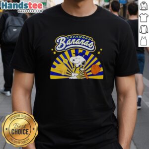 Premium Snoopy Savannah Bananas baseball t-shirt featuring Snoopy in a playful batting stance, perfect for dog lovers.