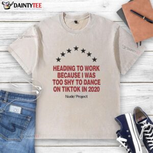 Person wearing a 'Nude Project Seven Stars' washed t-shirt heading to work, shy about dancing on TikTok in 2020.