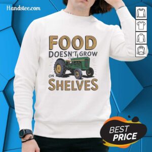 Alt Text: Vintage sweatshirt featuring a tractor and the phrase Food Doesn't Grow on Shelves, perfect for farm enthusiasts.