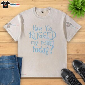 Pretty washed t-shirt hanging on a clothesline, inviting hugs with its soft texture and vibrant colors.