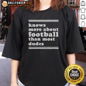 Hot women's tee featuring the phrase 'Knows More About Football Than Most Dudes' perfect for female football fans.