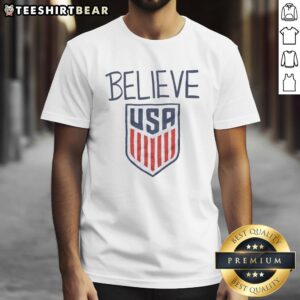 Alt Text: Nice Ted Lasso Believe X USA Crest T-Shirt featuring a vibrant design, perfect for fans of the hit series.