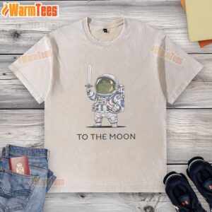 Alt Text: Official To The Moon Astronaut Frog washed t-shirt featuring a playful frog in a space suit on a soft fabric.