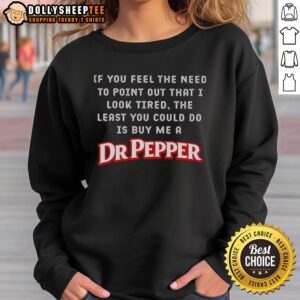 Woman wearing a Dr Pepper sweatshirt with a humorous caption about looking tired, perfect for casual wear.