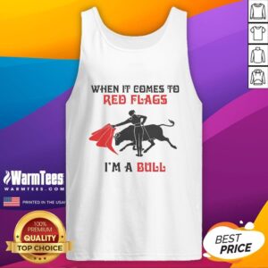 Model wearing a 'Good When It Comes to Red Flags I'm a Bull' tank top, showcasing trendy graphic apparel and stylish confidence.