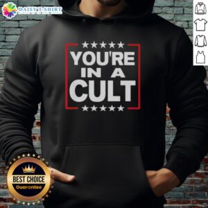 Person wearing a 'Nice, You're in a Cult' satirical political statement hoodie with stars design, promoting awareness.