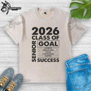 Class of 2026 senior grad wearing a washed t-shirt celebrating graduation with a big smile.