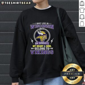 Cozy Minnesota Vikings sweatshirt with text 'I may live in Wisconsin, but my heart belongs to Vikings' in purple and gold.