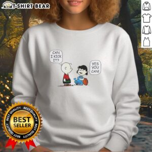 Top Charlie Brown and Lucy 'Can I Kick It?' sweatshirt featuring iconic cartoon characters in vibrant colors.