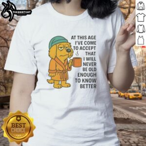 Alt Text: Sleepy dog in a robe holding a coffee mug, featured on the 'Never Old Enough To Know Better' ladies tee design.