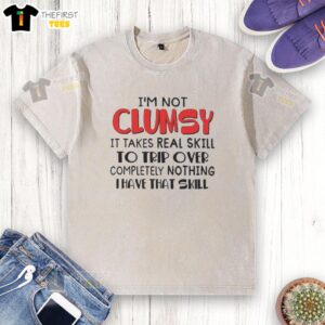 Funny washed t-shirt with 'I'm not clumsy, it takes skill to trip over nothing' text design, perfect for humorous outfits.