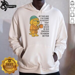 Sleepy dog in a cozy robe holding a coffee mug, showcasing the 'Never Old Enough to Know Better' hoodie design.