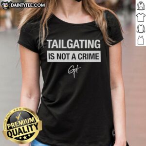 Alt Text: Guy Fieri in a signature ladies tee, showcasing the 'Tailgating Is Not A Crime' slogan at a lively tailgate event.