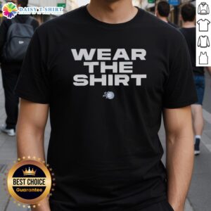 Orlando Magic fans proudly wearing stylish NBA T-shirts, showcasing team spirit and vibrant colors at a game.