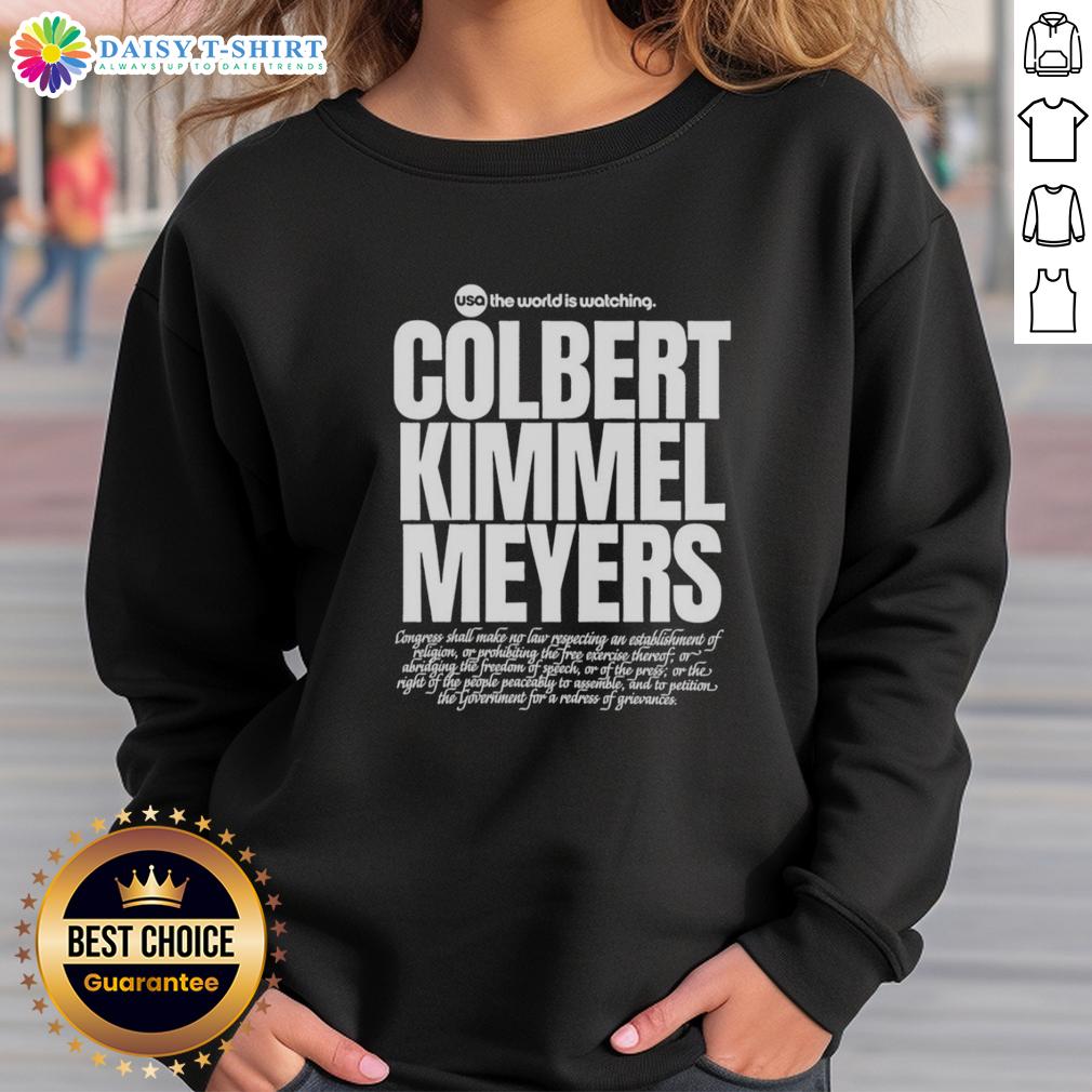 Top Usa The World Is Watching Colbert Kimmel Meyers Sweatshirt Top USA The World Is Watching sweatshirt featuring Colbert, Kimmel, and Meyers, showcasing a stylish, humorous design.