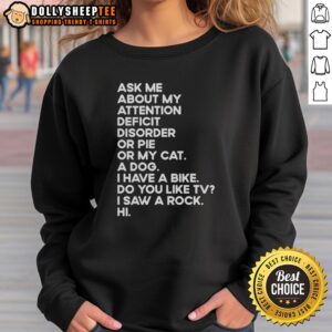 Person wearing a 'Ask Me About My Attention Deficit Disorder or Pie or My Cat' sweatshirt in a cozy setting.