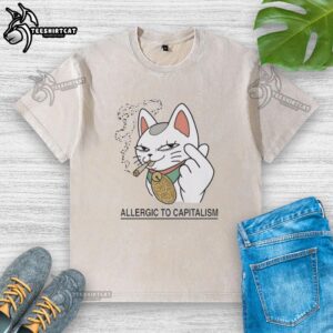 Nice Lucky Cat design on a washed t-shirt, playfully expressing 'Allergic to Capitalism' in a unique, vibrant style.