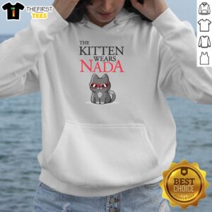 Cute kitten wearing a Nada hoodie, showcasing its playful personality and adorable charm in a cozy setting.